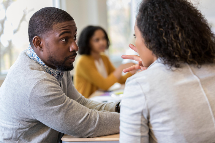 Surprised mid-adult African-American male looks at coworker