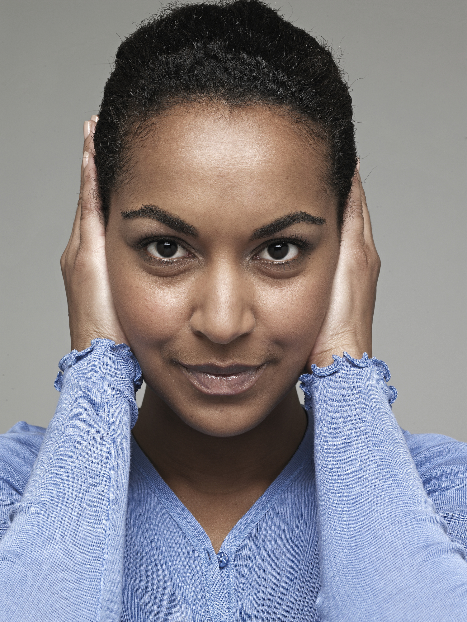 Mid-Adult Woman Covering Ears with Hands