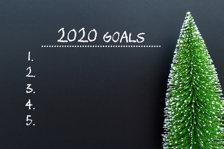 2020 Goals text on black board with Christmas tree