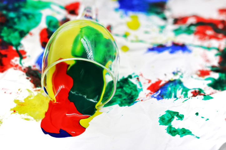 Close-Up Of Wineglass With Messy Paints On Fabric