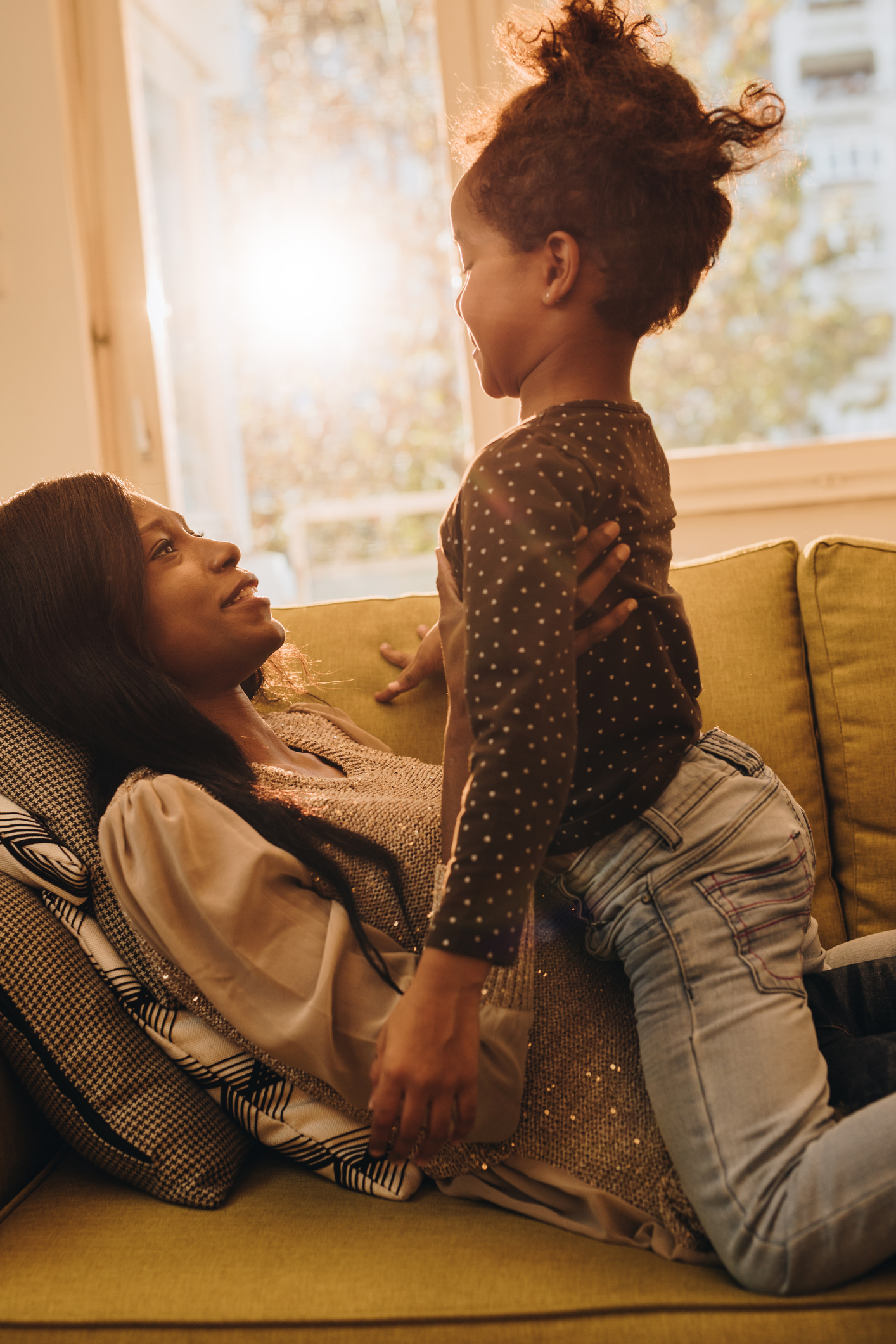 African American mother and daughter talking and having fun at home.