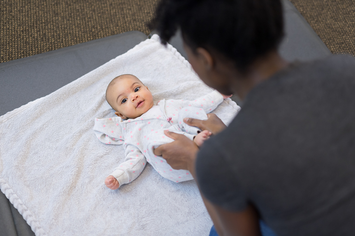 Cute baby does exercises with a physical therapist at a clinic