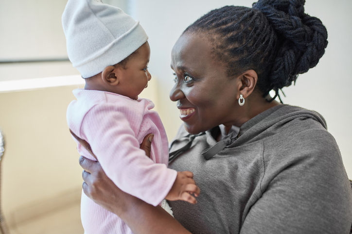 African grandmother holding her granddaughter