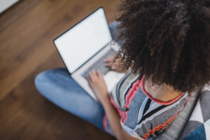 Young woman using her laptop at home