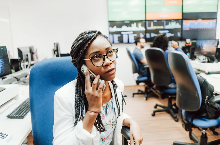 business woman talking on phone in office