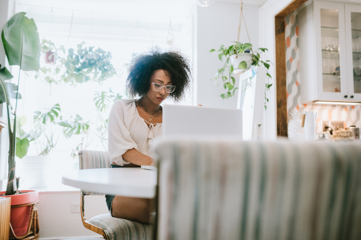 A Young Woman Works From Home on Her Laptop