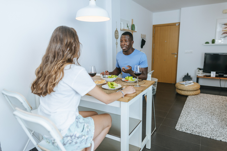 Couple having a meal in living room