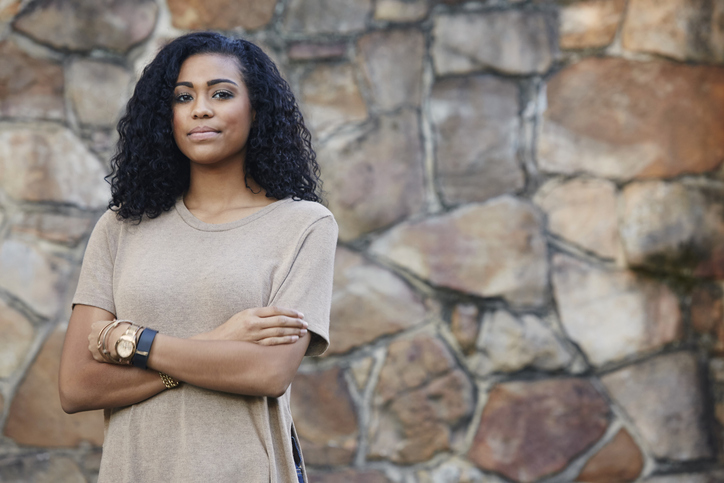 Young woman with crossed arms