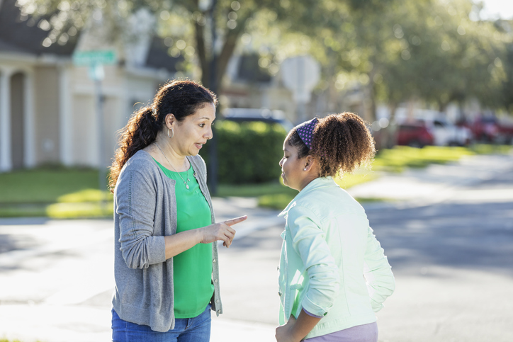 Hispanic mother disciplining daughter, or giving advice