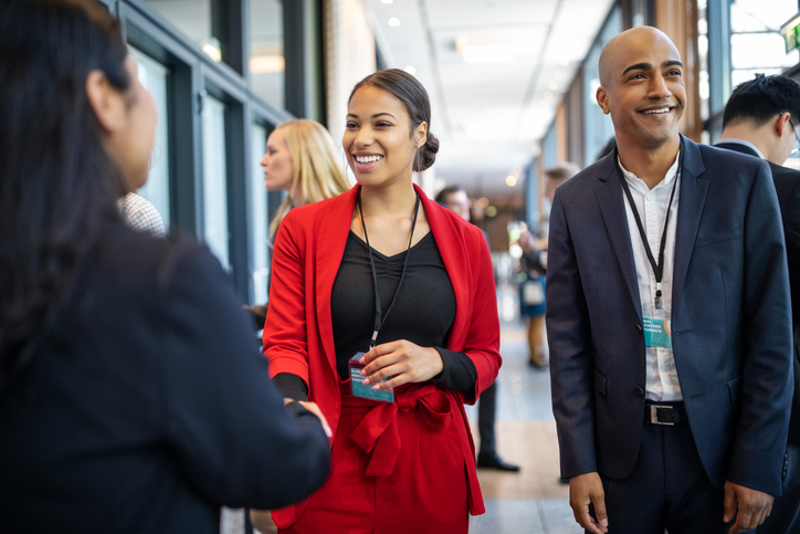 Business people greeting each other in coffee break at seminar