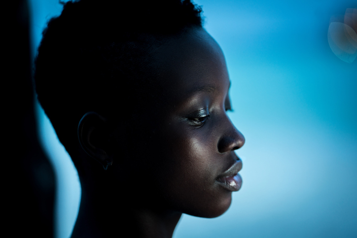 Black woman in tropical resort at night