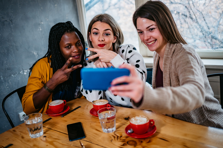 Girl friends making selfie at coffee time