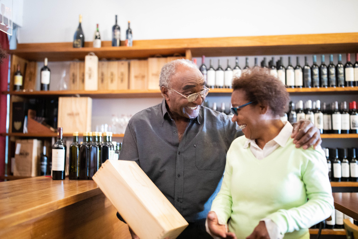 Smiling senior couple at a winery store