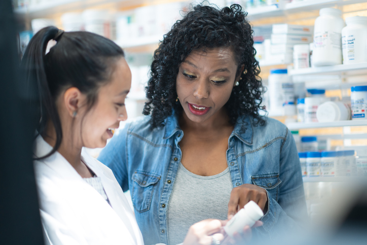 Woman Consulting with a Pharmacist About Medication stock photo