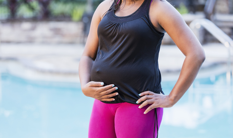 Midsection of pregnant African-American woman