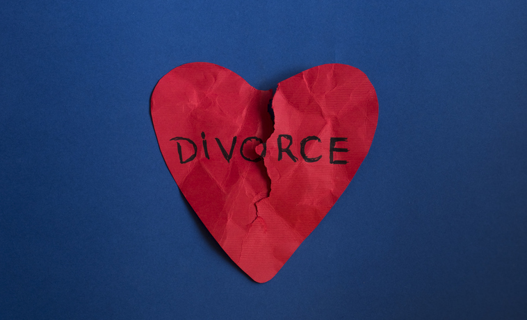Close-Up Of Heart Shape On Paper Against Blue Background. Divorce Concept