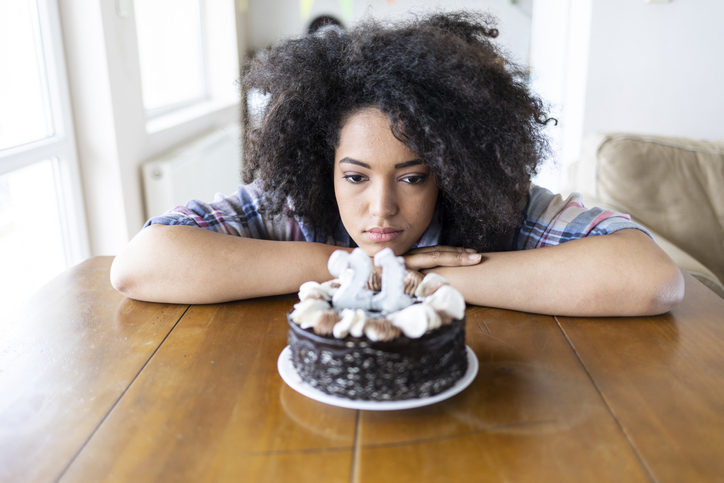 Young woman and birthday cake