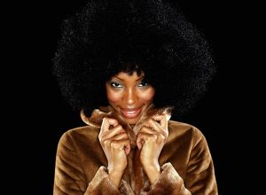Young woman in fur coat with afro