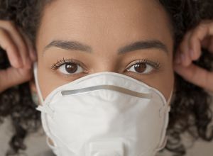 Close-Up Portrait Of Woman Wearing Pollution Mask