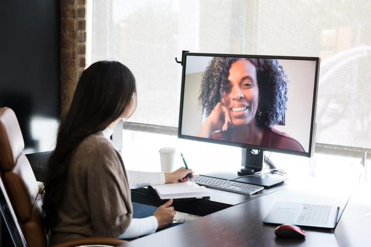 Businesswoman talks with female colleague online