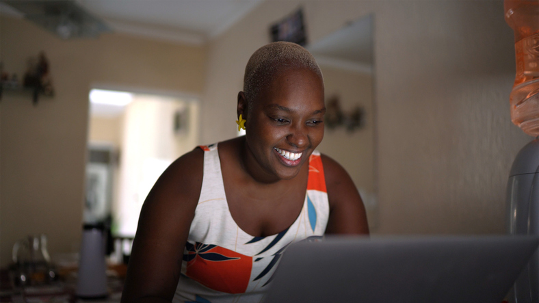 Portrait of mid adult woman using laptop at home