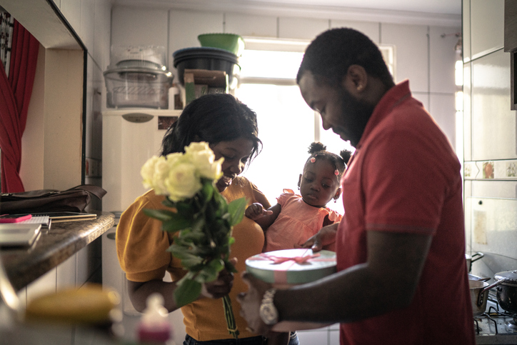 Husband doing a birthday surprise for her wife