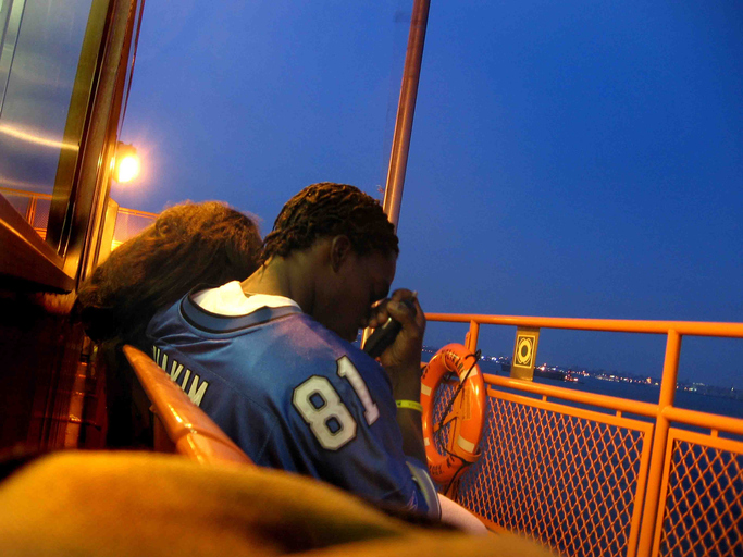 A couple sitting on deck of the Staten Island Ferry in New York City