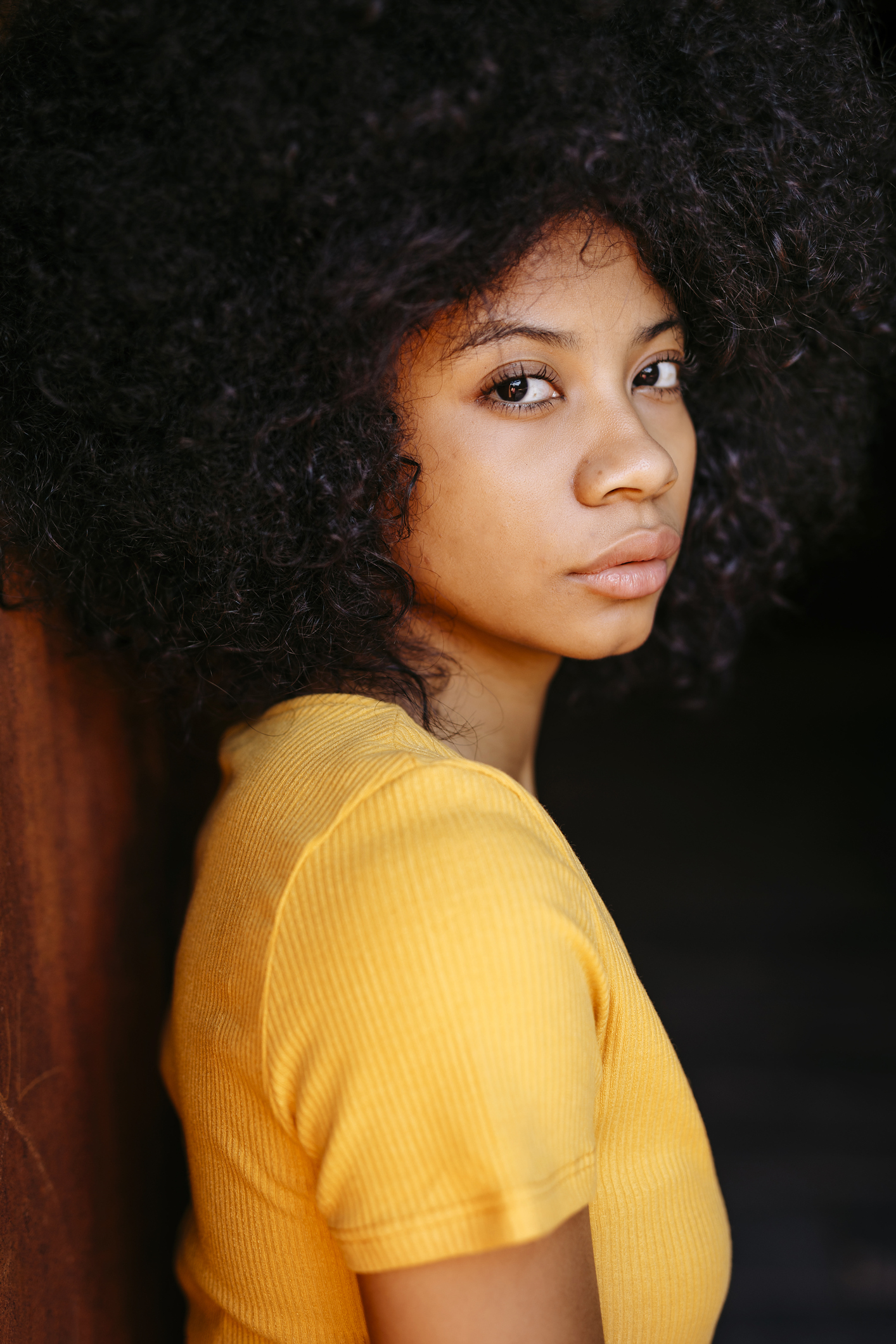 Portrait of young woman in yellow shirt