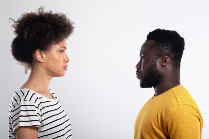 Portrait of African-American young man and woman standing face to face