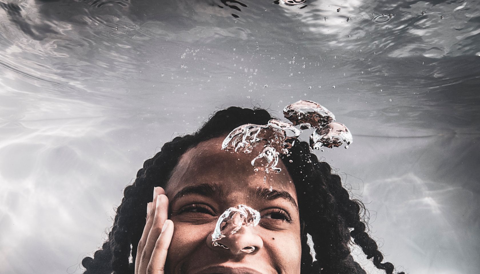 African American female posing under water