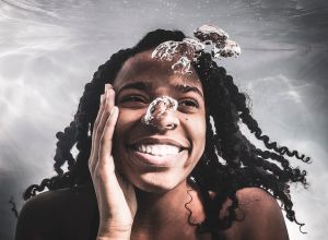 African American female posing under water