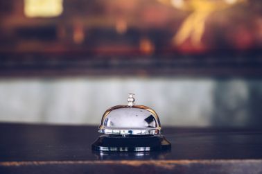 A front desk bell on hotel reception counter.