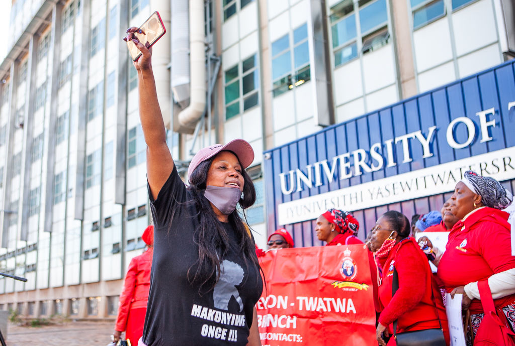 Demonstrators protest against COVID-19 vaccine trials in Africa at Wits University in South Africa