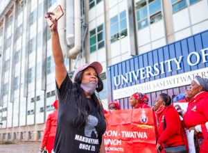 Demonstrators protest against COVID-19 vaccine trials in Africa at Wits University in South Africa