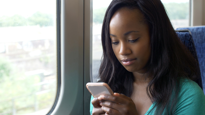 Phone reading message on train journey.