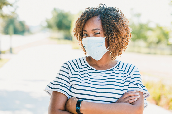 On walk outside mid adult woman wears protective mask