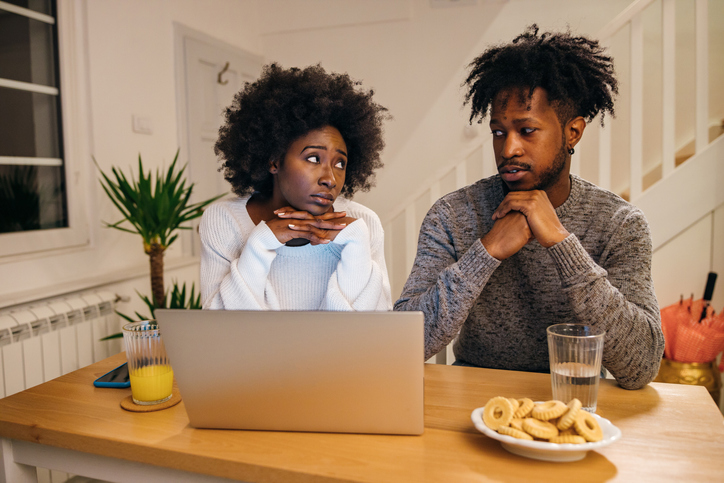Worried couple using laptop