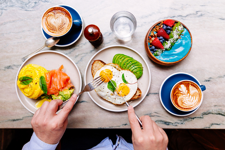 Man eating breakfast at the restaurant, personal perspective view