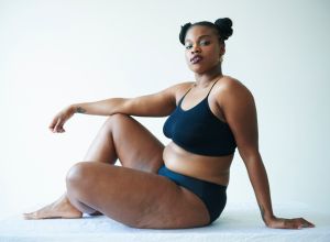 confident curvy woman sitting and looking to camera