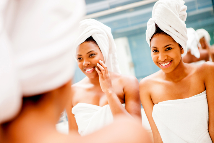 Happy black female friends having fun at a spa talking and smiling,