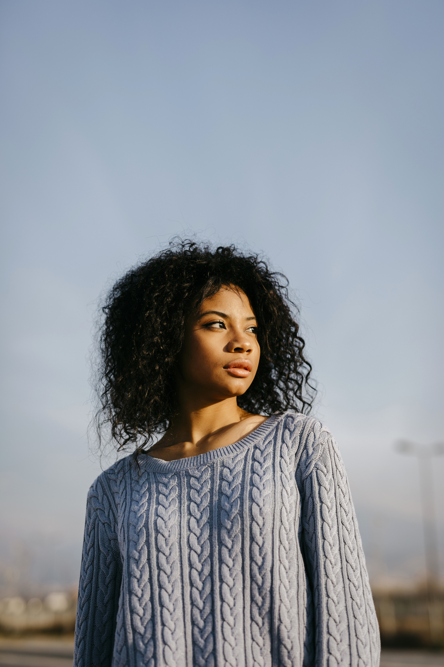 Beautiful young woman outdoors under blue sky