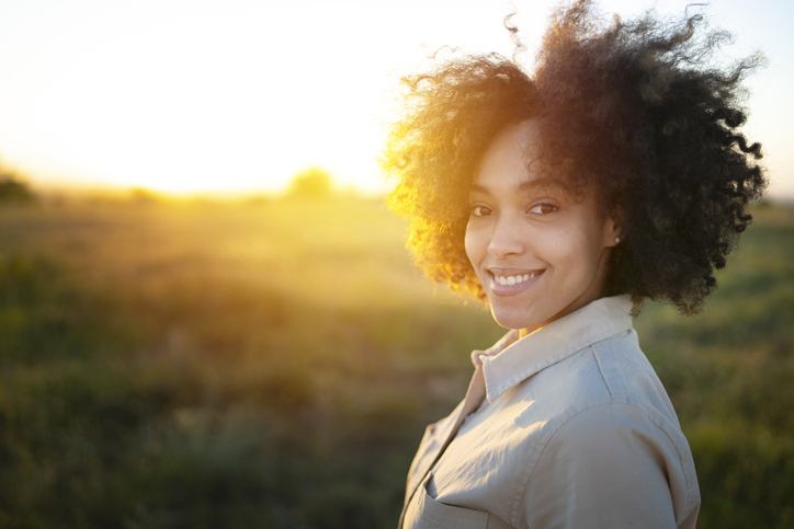 Portrait of a young afro woman at sunset