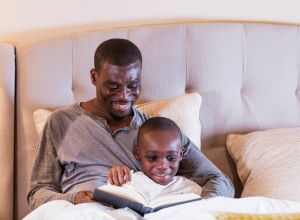 Father reading bedtime story to son