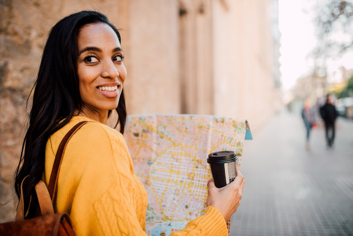 Girl enjoying her journey with coffee and sightseeing