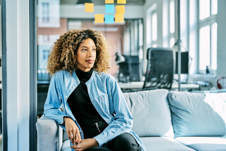 Contemplated businesswoman sitting in office