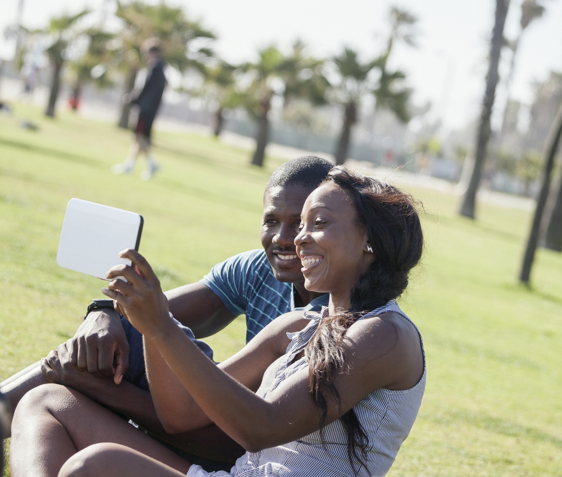 Young couple using tablet, browsing the internet