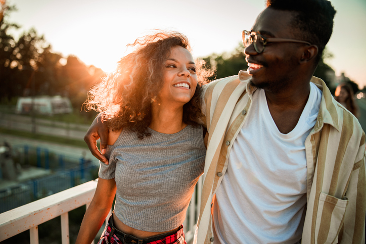 Happy black couple enjoying in their walk at sunset.