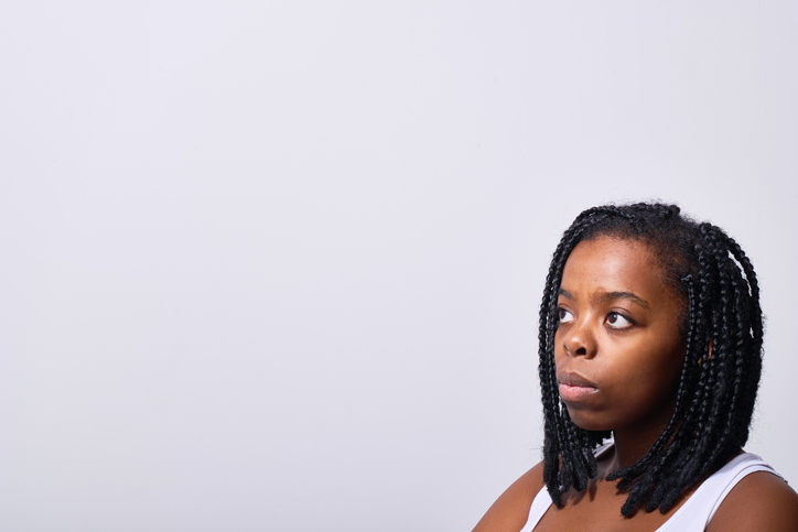 Contemplative young black woman looking away