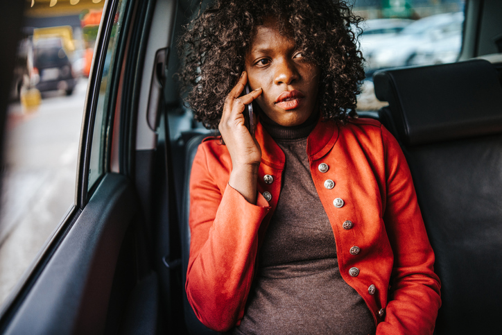 Woman using phone in car
