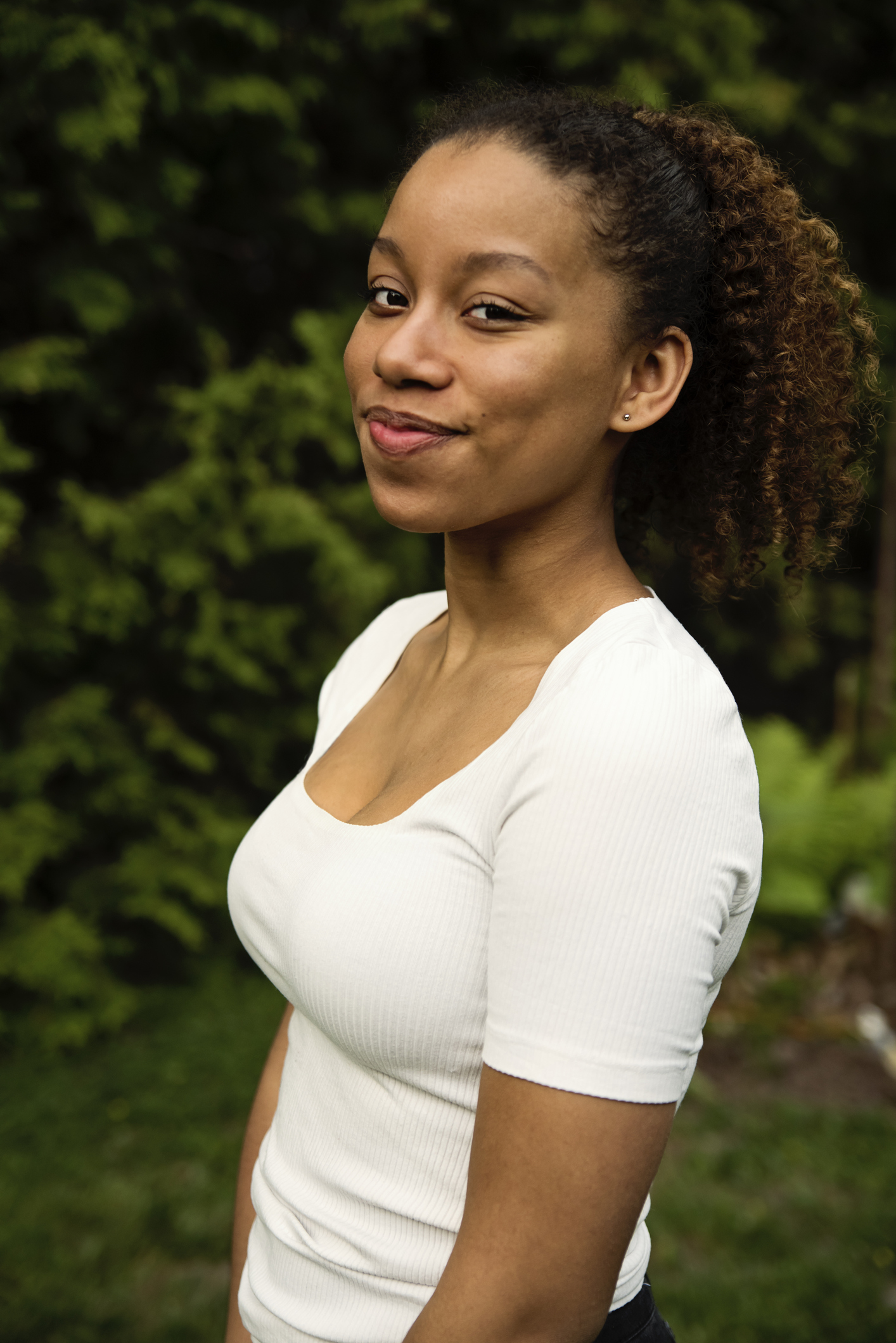Portrait of beautiful mixed-race teenage girl in backyard.